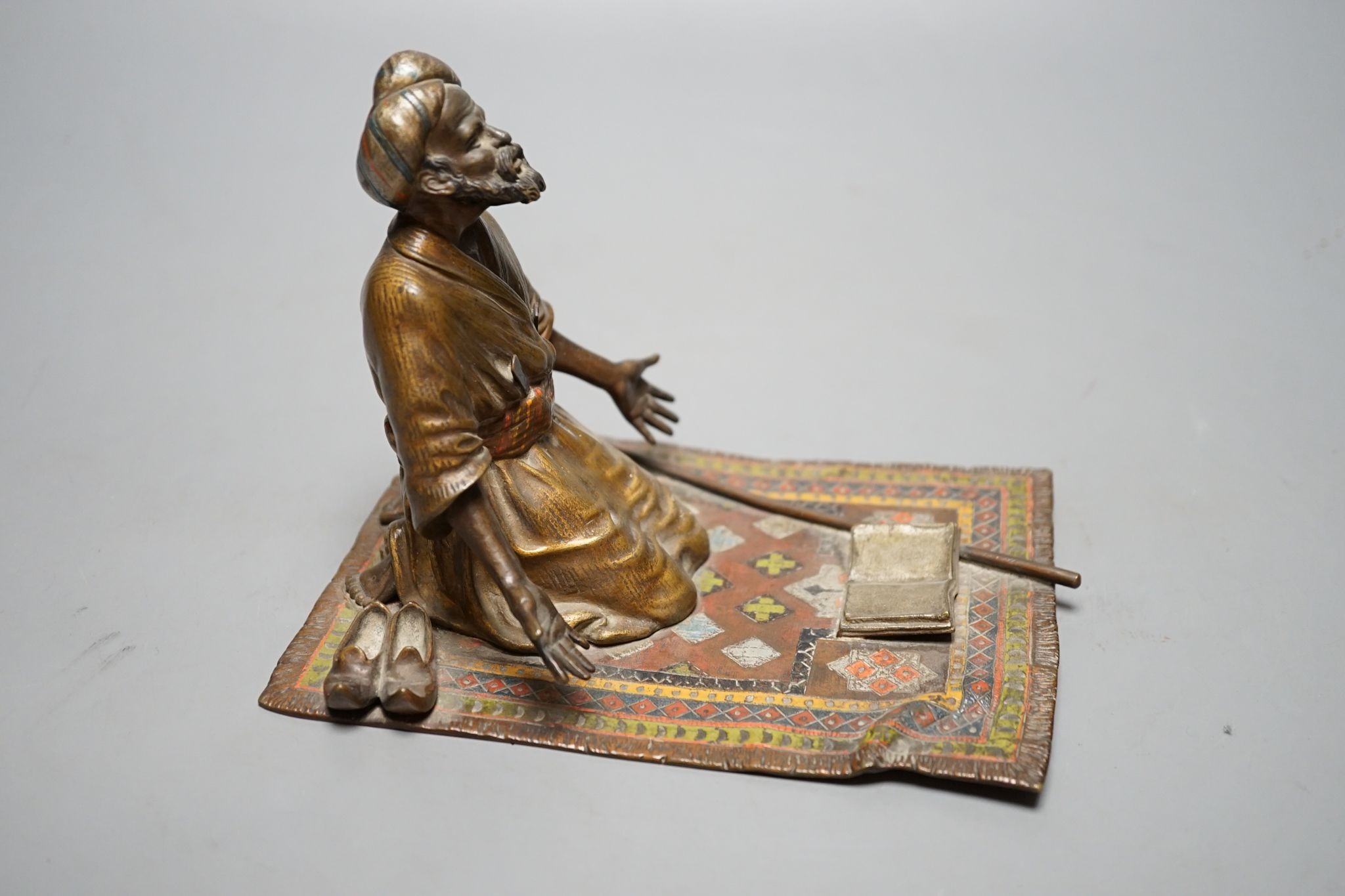 An enamelled, cold-painted bronze kneeling figure, unsigned, probably Franz Bergman, 16 cms deep x 13 cms high.